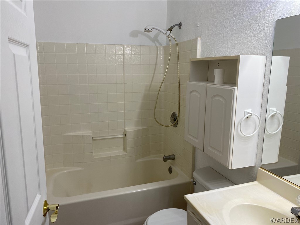 170 Aztec Road Golden Valley, AZ 86413 - Photo 19 of 28 a bathroom with a toilet and shower
