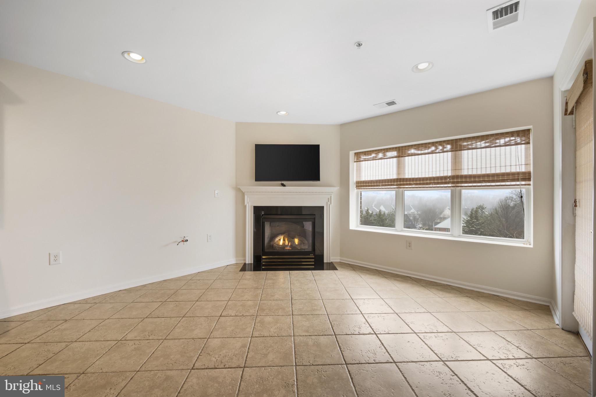 12246 Roundwood Road, Unit 707 Lutherville-Timonium, MD 21093 - Photo 8 of 24 Family room off kitchen with gas fireplace