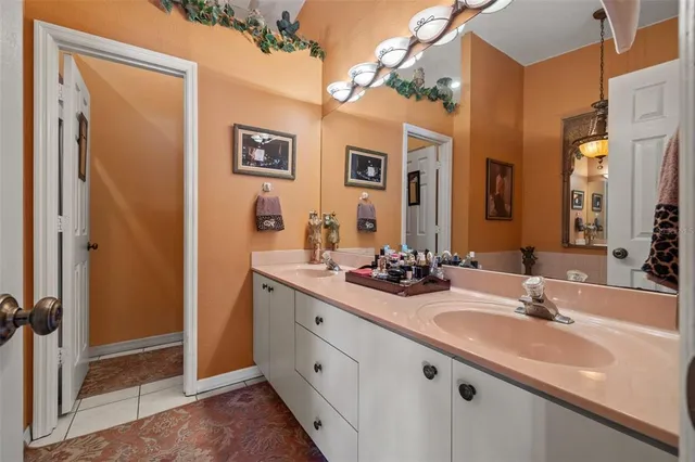 a bathroom with a double vanity sink and a mirror
