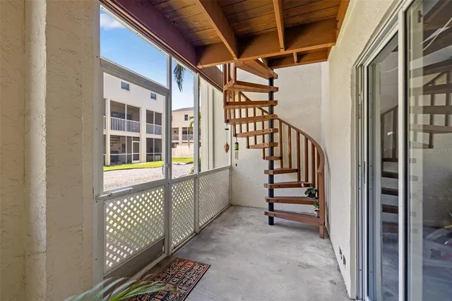 an aerial view of multiple houses with a yard