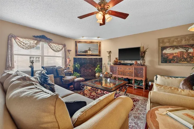 a living room with furniture a large window and a flat screen tv