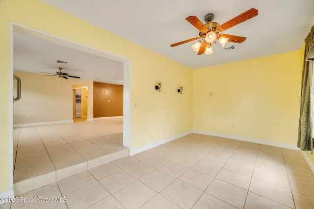 an empty room with fan and fan