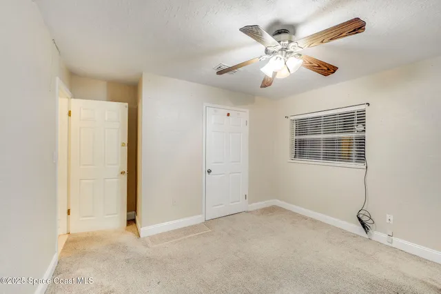 an empty room with windows and closet