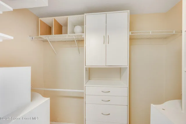 a backyard of a house with fountain table and chairs