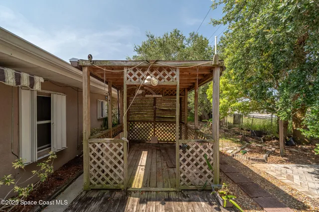 a backyard of a house with table and chairs