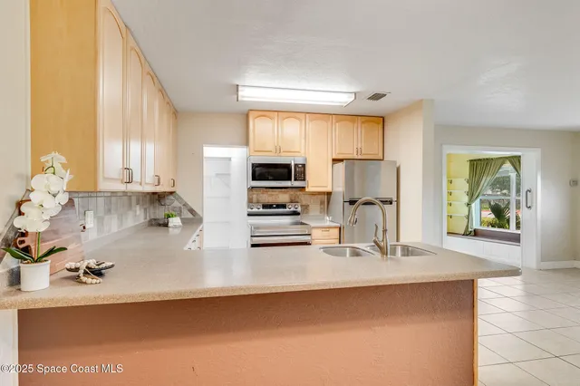 a kitchen with stainless steel appliances a sink a stove and microwave