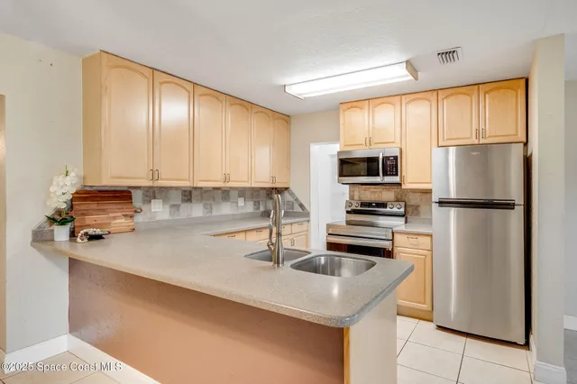 a large white kitchen with cabinets