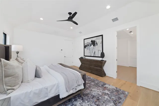 a bedroom with a bed and painting on the wall