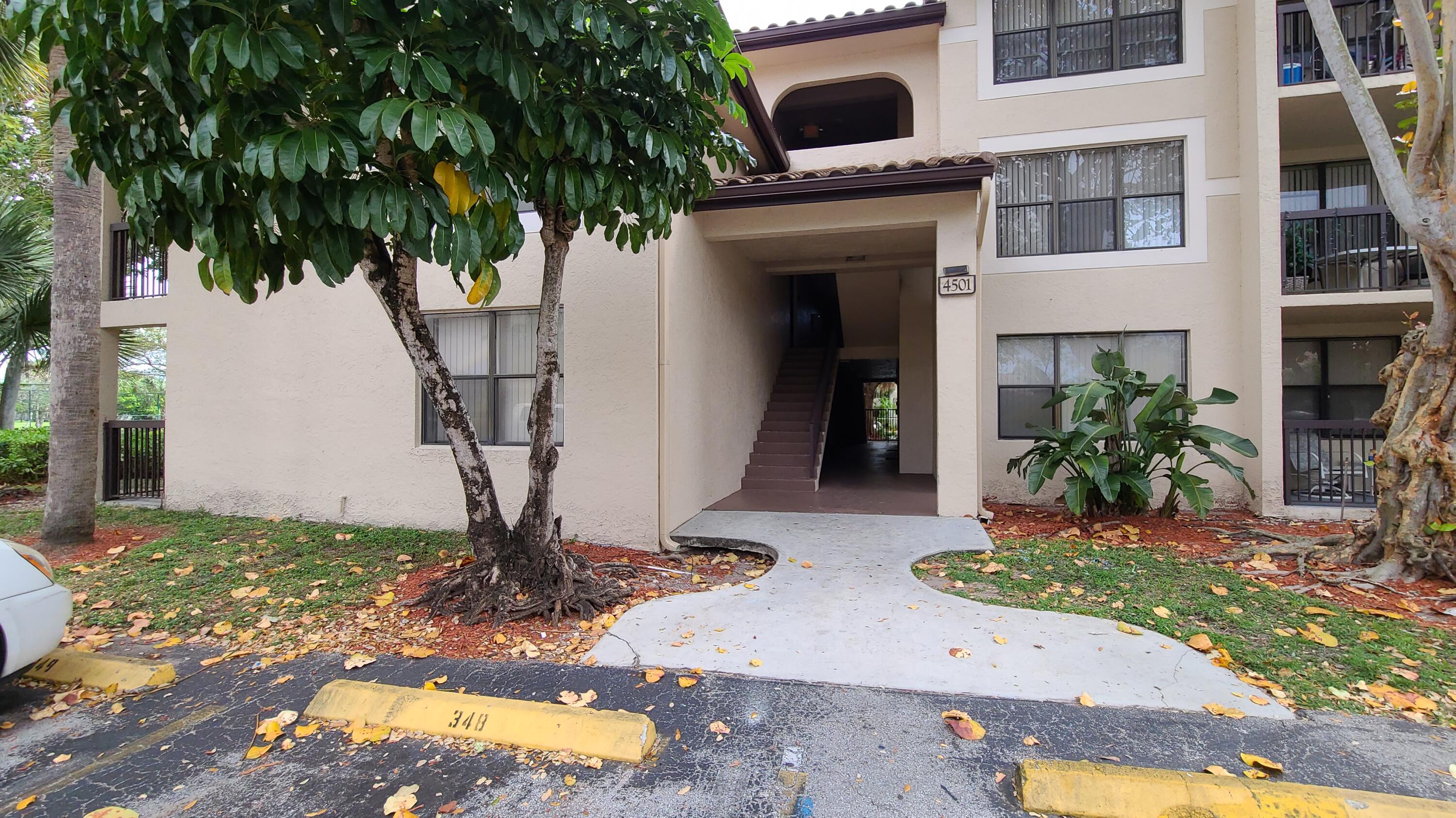 4501 West McNab Road, Unit 11 Pompano Beach, FL 33069 - Photo 31 of 32 a front view of a house with a yard