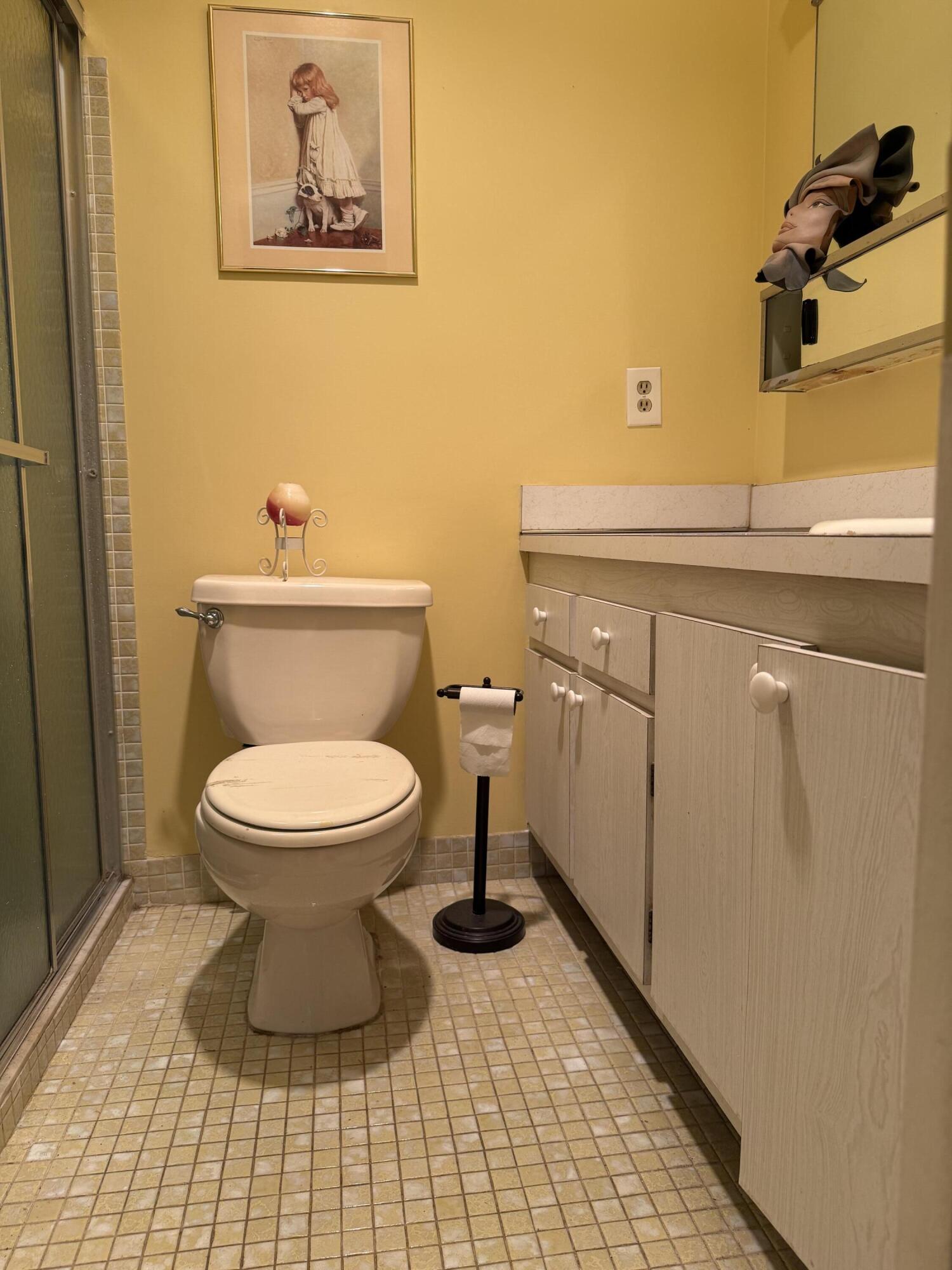 3311 Valley Road, Unit D Boynton Beach, FL 33435 - Photo 16 of 26 a bathroom with a toilet and a mirror