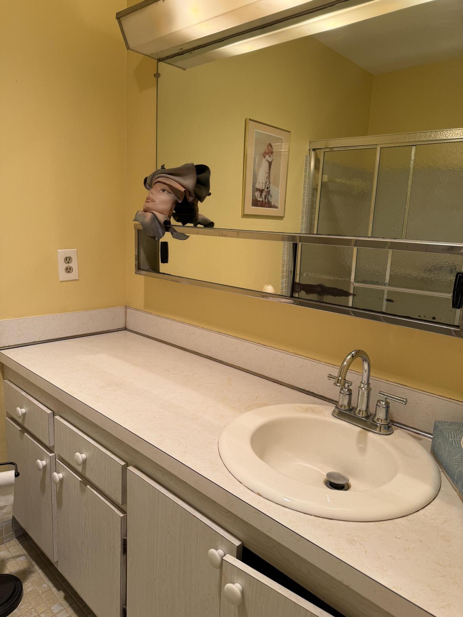 3311 Valley Road, Unit D Boynton Beach, FL 33435 - Photo 18 of 26 a bathroom with a sink and a mirror
