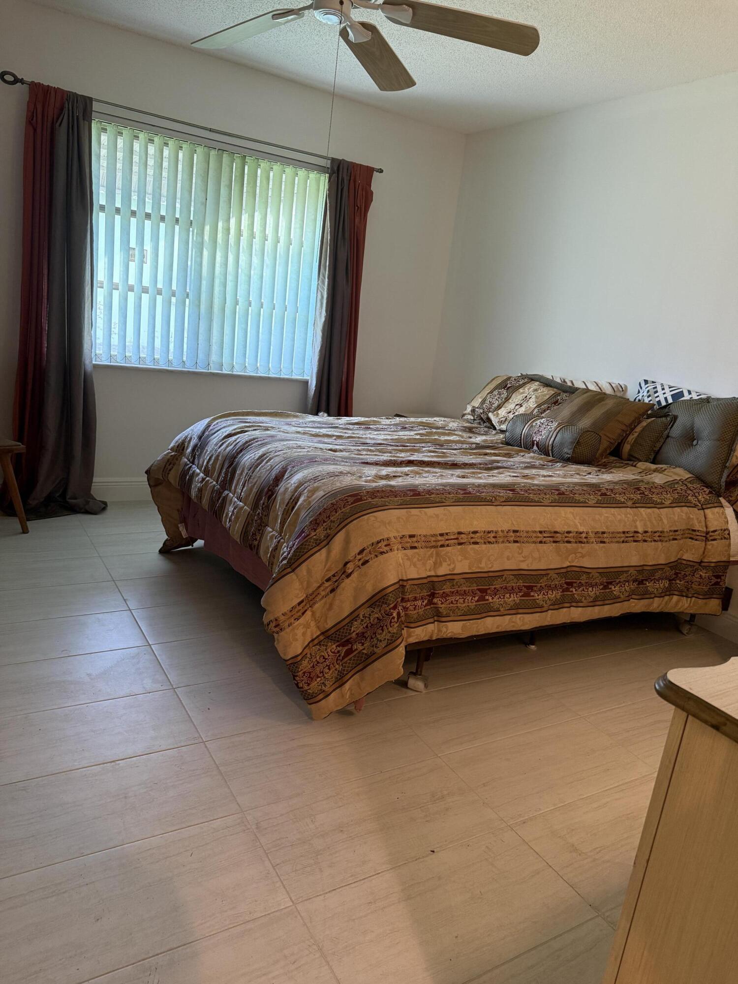 3311 Valley Road, Unit D Boynton Beach, FL 33435 - Photo 19 of 26 a bedroom with a bed and window