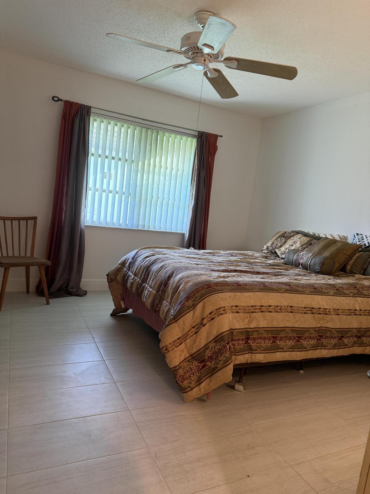 3311 Valley Road, Unit D Boynton Beach, FL 33435 - Photo 21 of 26 a bedroom with a bed and a window