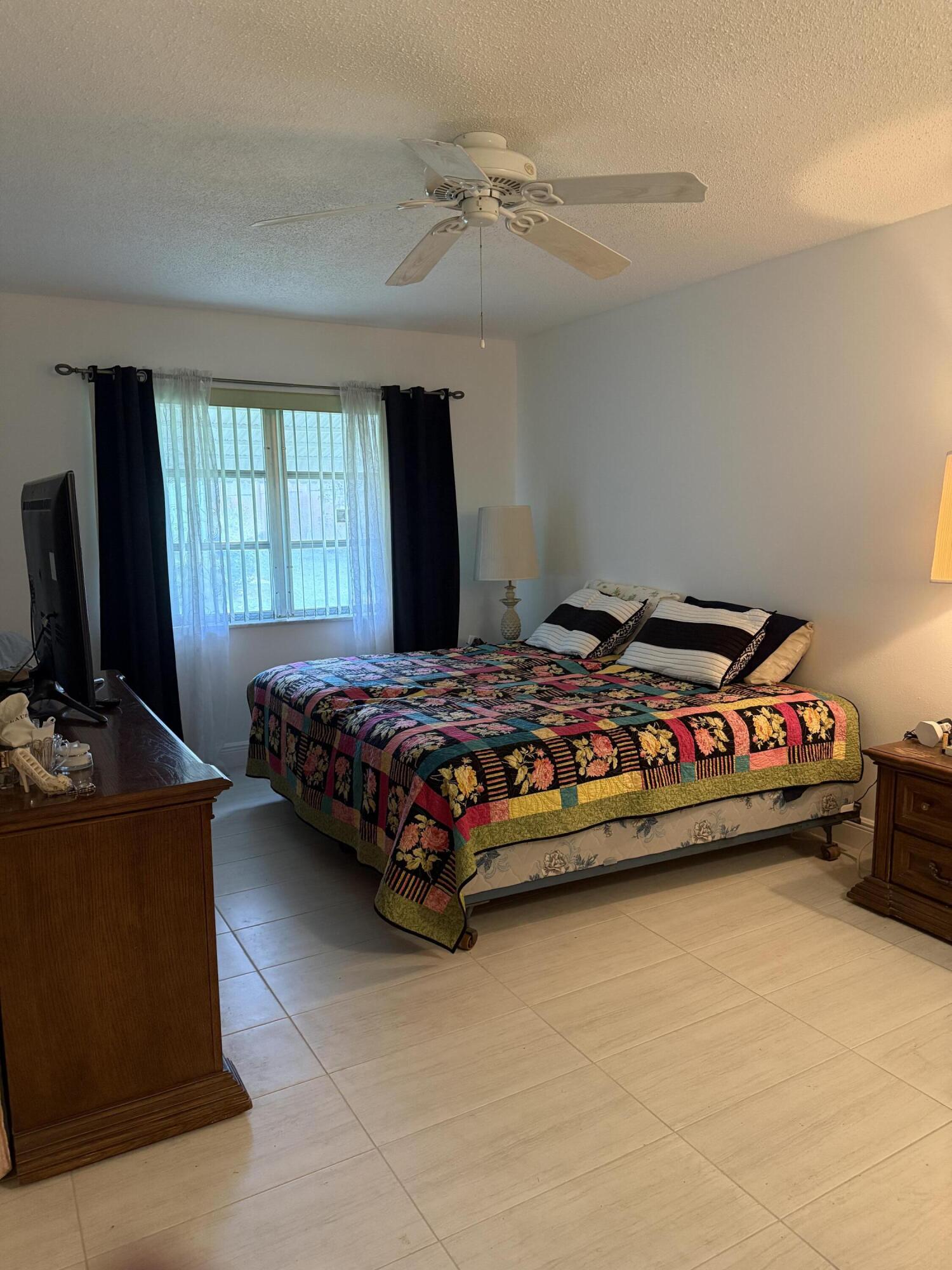 3311 Valley Road, Unit D Boynton Beach, FL 33435 - Photo 22 of 26 a bedroom with a bed and a flat screen tv