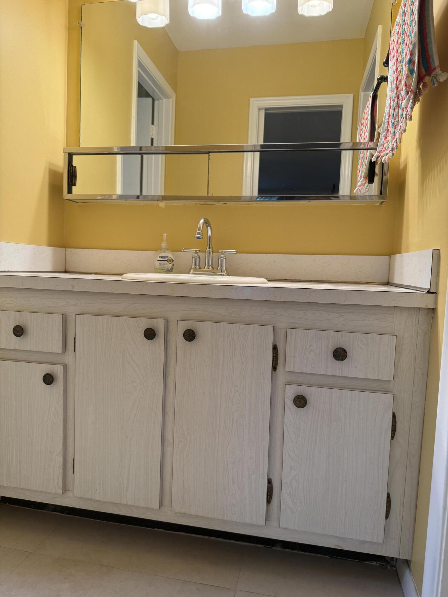 3311 Valley Road, Unit D Boynton Beach, FL 33435 - Photo 24 of 26 a bathroom with a sink and a cabinets