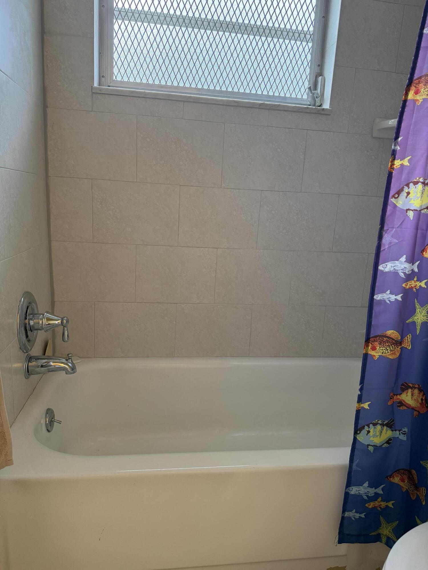 3311 Valley Road, Unit D Boynton Beach, FL 33435 - Photo 25 of 26 a bathroom with a bathtub