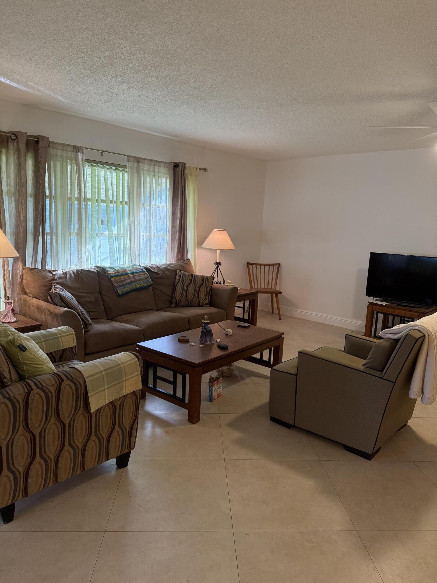 3311 Valley Road, Unit D Boynton Beach, FL 33435 - Photo 5 of 26 a living room with furniture and a window