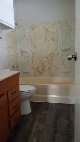 a bathroom with a toilet a sink and a shower
