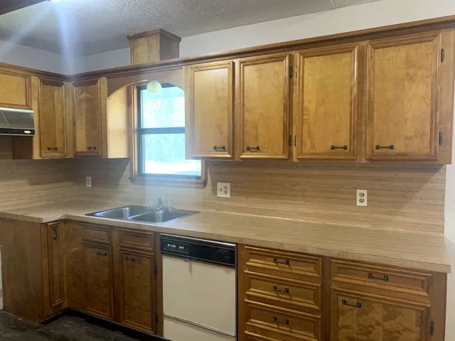 a kitchen with stainless steel appliances granite countertop a sink a stove and a microwave