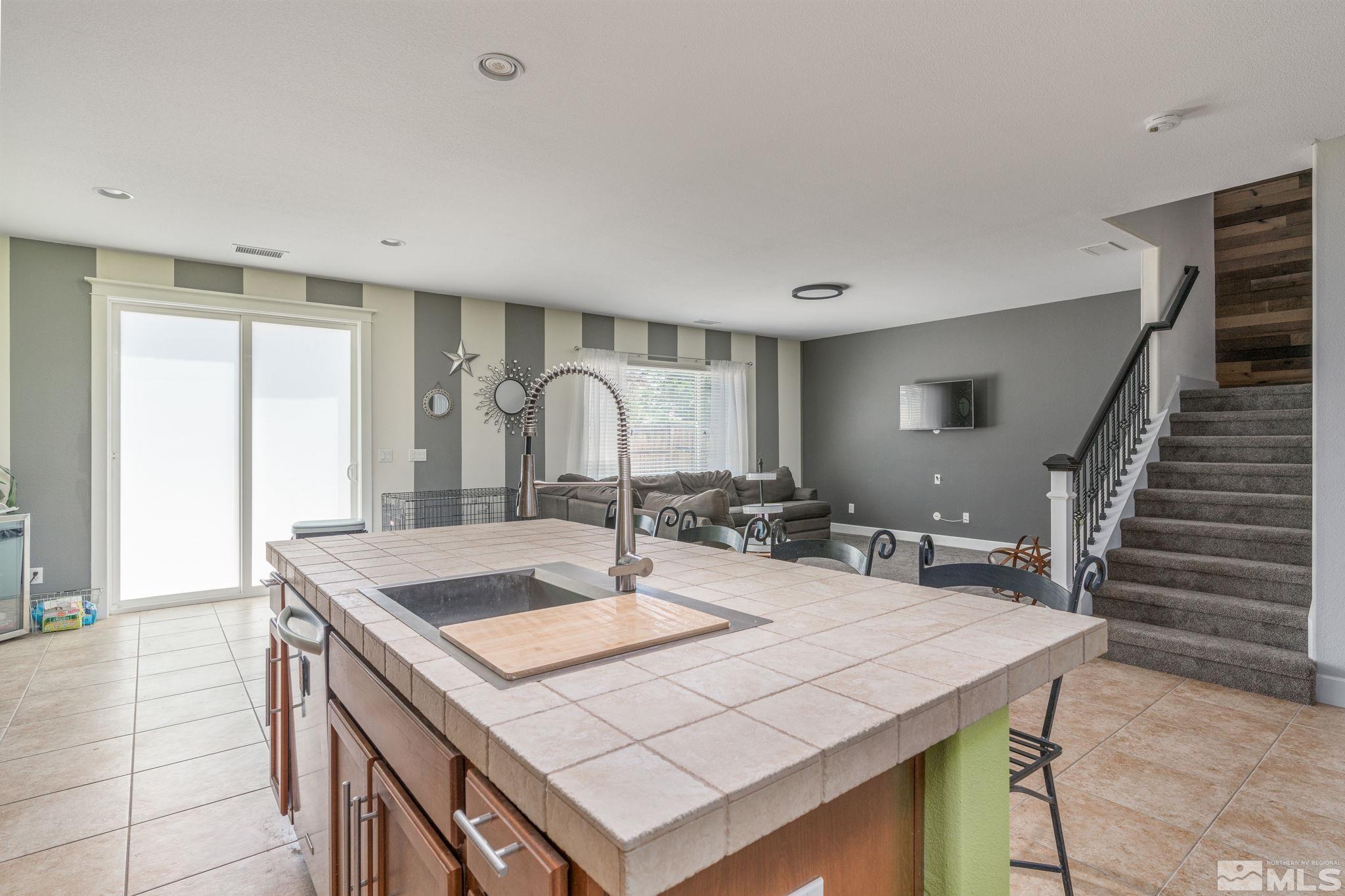 9360 Spotted Horse Road Reno, NV 89521 - Photo 15 of 38 a view of a kitchen area with furniture and wooden floor