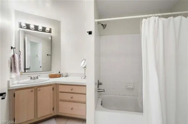 a bathroom with a sink a mirror and a shower