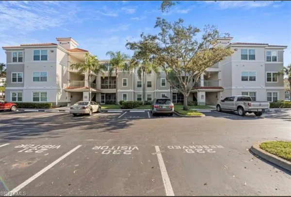a building with car parked in front of it