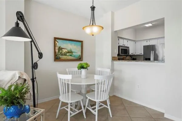 a view of a dining room with furniture and a chandelier