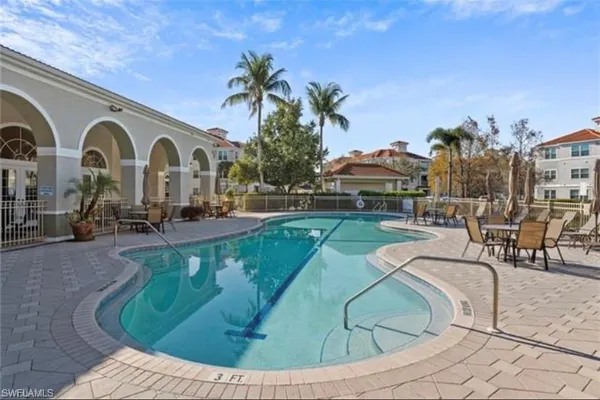 a view of a swimming pool with outdoor seating