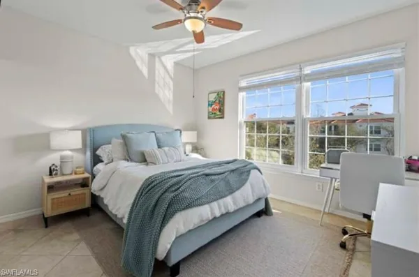 a bed room with a bed and a chair