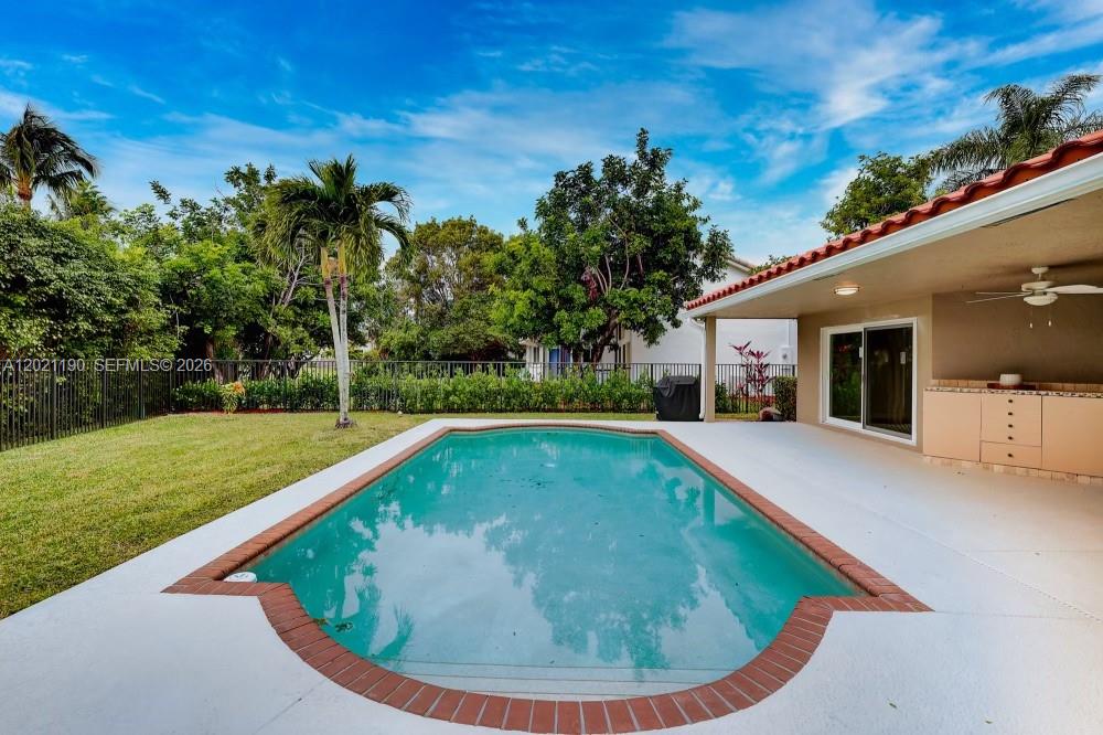 814 Heron Road Weston, FL 33326 - Photo 25 of 27 a view of swimming pool with a garden