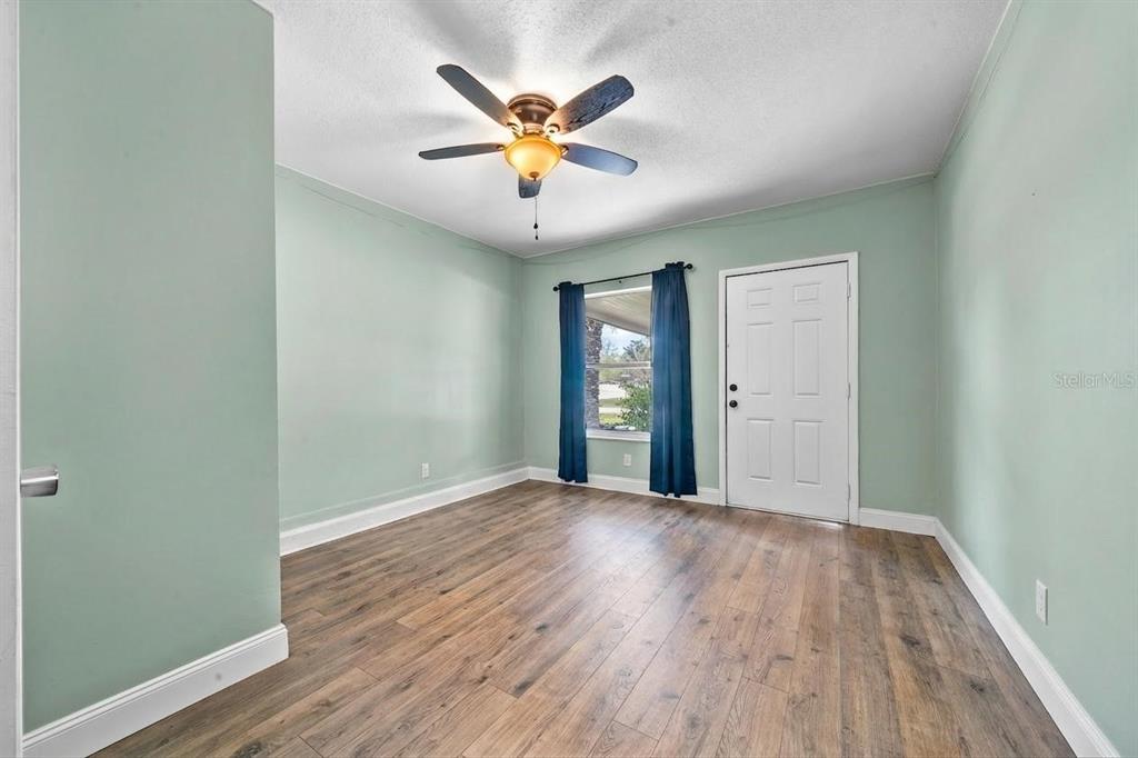 9318 Spring Terrace Ocala, FL 34472 - Photo 13 of 19 wooden floor in an empty room with a window