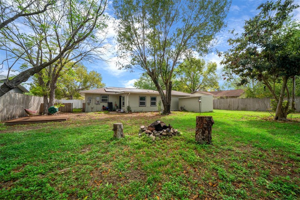 9318 Spring Terrace Ocala, FL 34472 - Photo 17 of 19 a view of a house with backyard and a tree