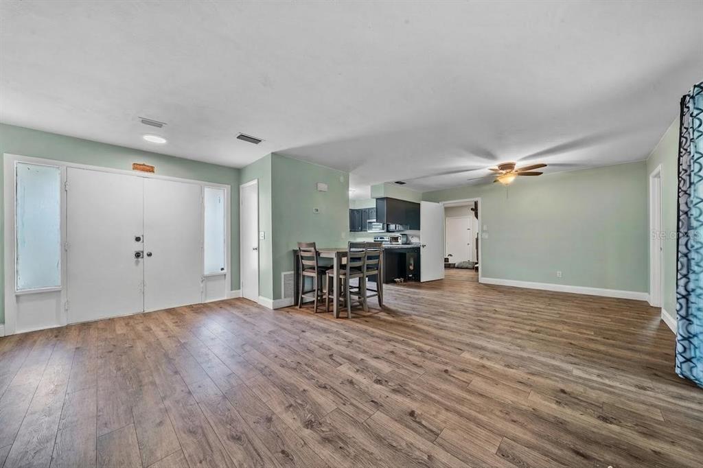 9318 Spring Terrace Ocala, FL 34472 - Photo 3 of 19 a view of a livingroom with furniture wooden floor and ceiling fan