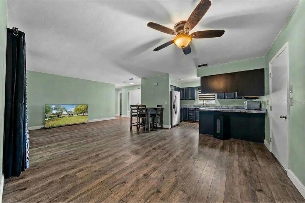 9318 Spring Terrace Ocala, FL 34472 - Photo 4 of 19 a living room with stainless steel appliances furniture and a flat screen tv