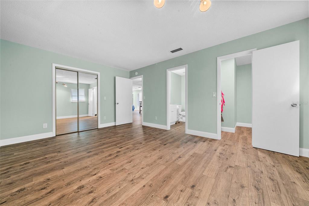 9318 Spring Terrace Ocala, FL 34472 - Photo 7 of 19 a view of an empty room with wooden floor and closet
