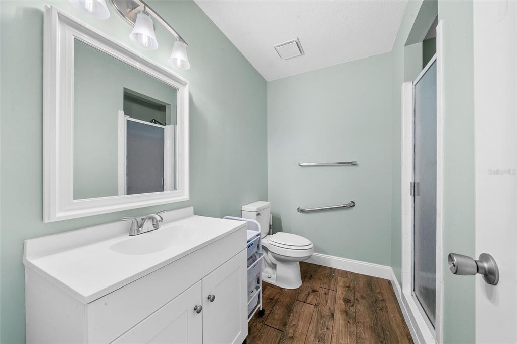 9318 Spring Terrace Ocala, FL 34472 - Photo 8 of 19 a bathroom with a sink toilet a mirror and vanity