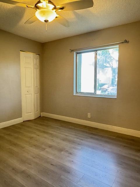 4969 Sable Pine Circle, Unit D1 West Palm Beach, FL 33417 - Photo 12 of 24 a view of an empty room with wooden floor and a window
