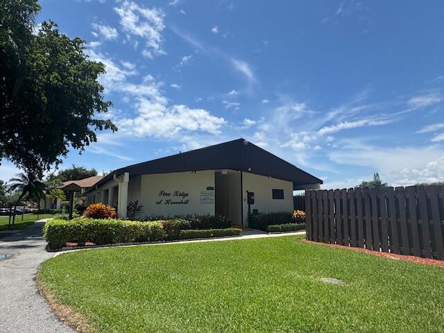 4969 Sable Pine Circle, Unit D1 West Palm Beach, FL 33417 - Photo 20 of 24 a front view of a house with garden