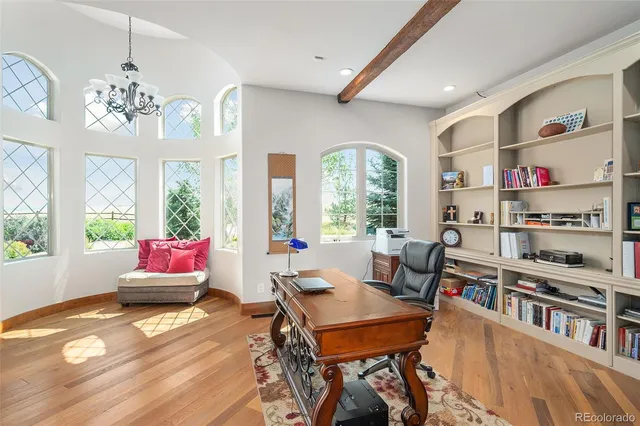 a living room with furniture and a bookshelf