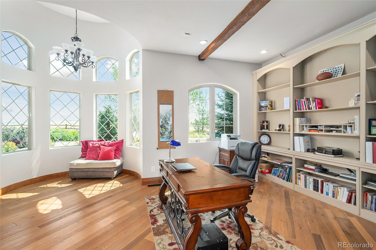5740 Lambert Ranch Trail Sedalia, CO 80135 - Photo 13 of 48 a living room with furniture and a bookshelf