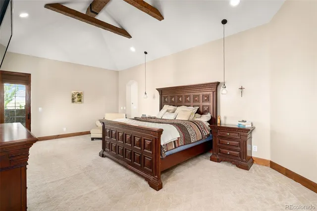 a bedroom with a bed and a chandelier