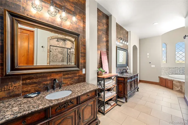 a bathroom with double vanity sinks and a mirror
