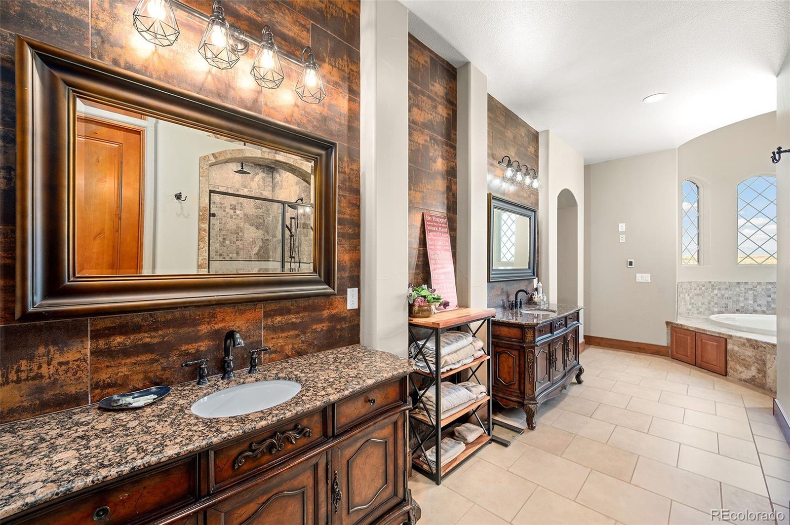 5740 Lambert Ranch Trail Sedalia, CO 80135 - Photo 15 of 48 a bathroom with double vanity sinks and a mirror