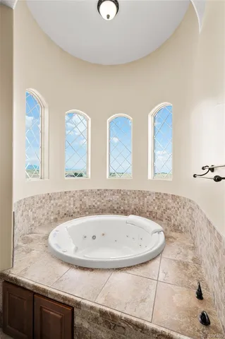 a bathroom with windows and bathtub