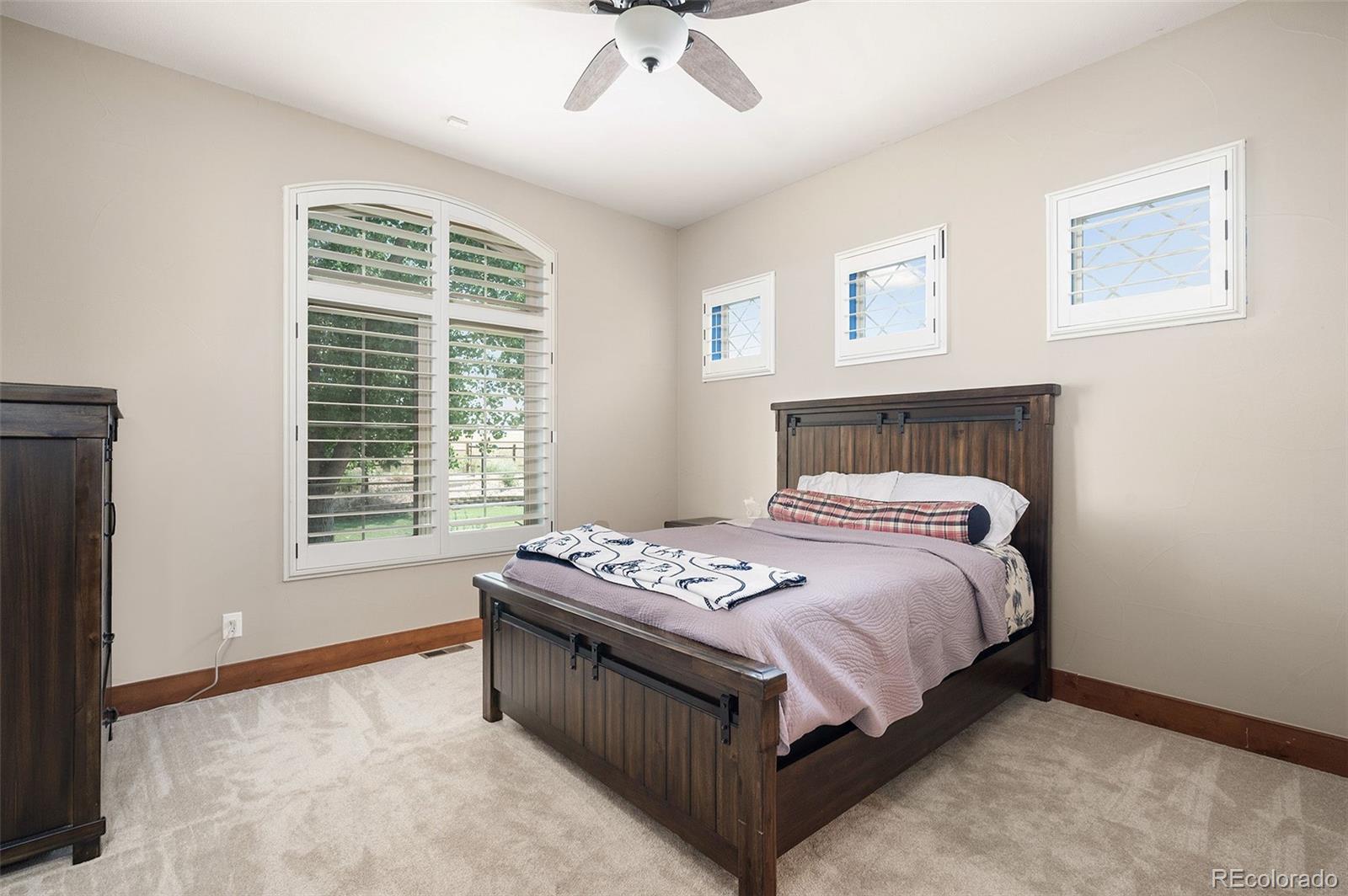 5740 Lambert Ranch Trail Sedalia, CO 80135 - Photo 18 of 48 a bedroom with a bed and a window