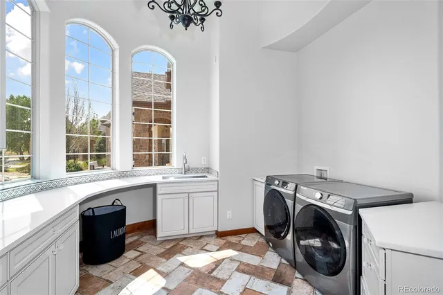 a utility room with sink dryer and washer