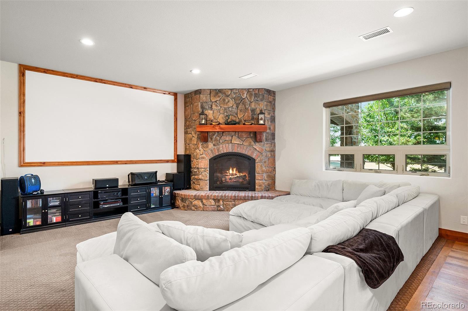 5740 Lambert Ranch Trail Sedalia, CO 80135 - Photo 26 of 48 a living room with furniture fireplace and a large window