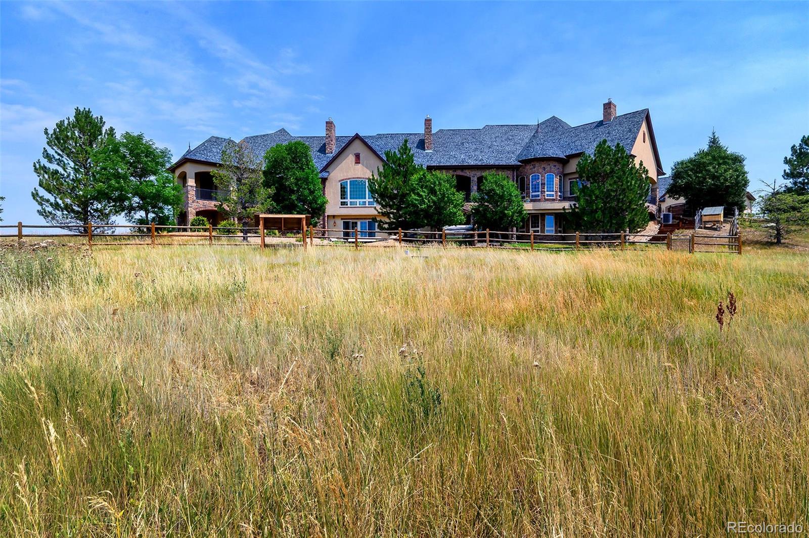 5740 Lambert Ranch Trail Sedalia, CO 80135 - Photo 41 of 48 a front view of house with a yard and swimming pool