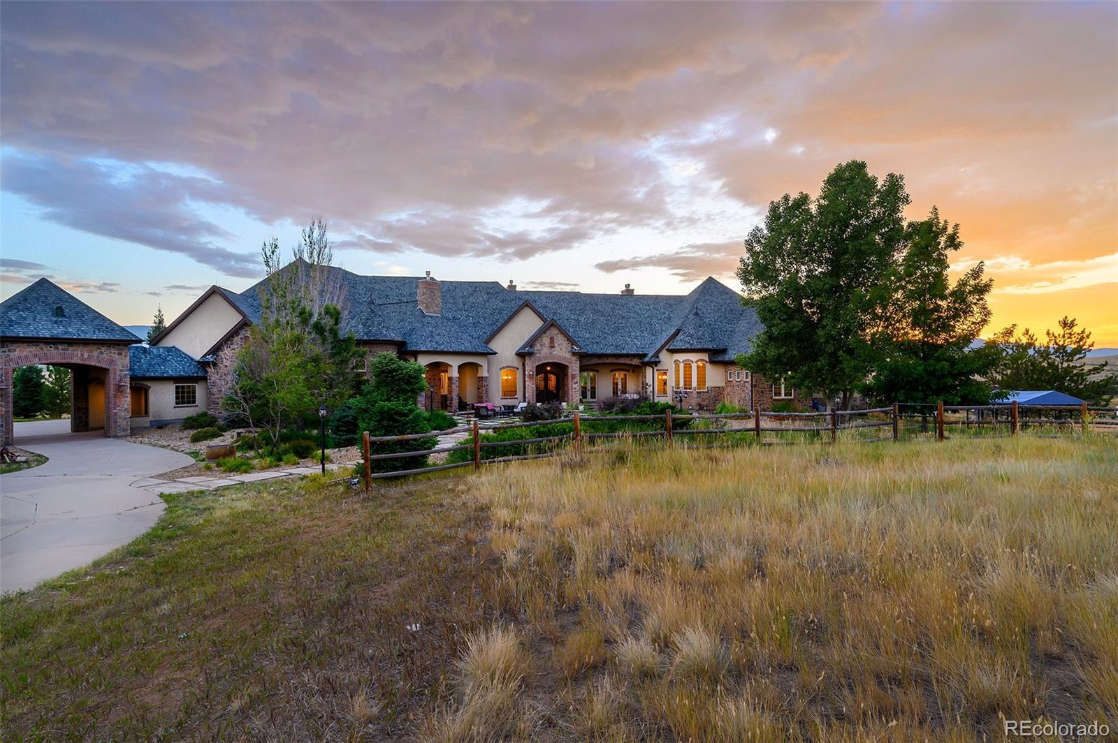 5740 Lambert Ranch Trail Sedalia, CO 80135 - Photo 43 of 48 a front view of a house with yard and lake view