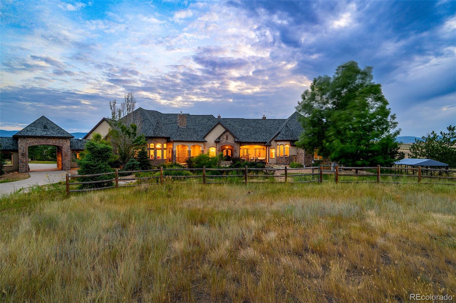5740 Lambert Ranch Trail Sedalia, CO 80135 - Photo 44 of 48 a view of a house with pool and a yard